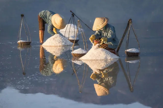The colourful process of salt harvesting is captured at the Hon Khoi Salt Fields in Nha Trang, Vietnam in December 2022. (Photo by Hilton Chen/Solent News & Photo Agency)