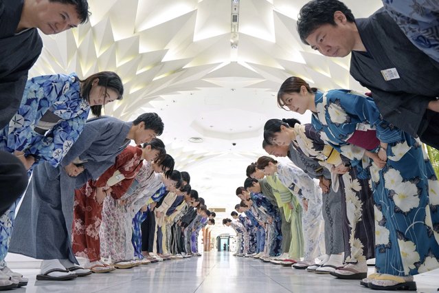Sales clerks of the Nihonbashi Mitsukoshi department store clad in yukata, a Japanese unlined cotton summer kimono dress, greet customers in Tokyo on July 7, 2025. (Photo by Kazuhiro Nogi/AFP Photo)