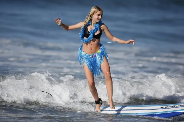 Dagny Weakley, 13, surfs dressed as a hula dancer during the ZJ Boarding House Haunted Heats Halloween Surf Contest in Santa Monica, California, United States, October 31, 2015. (Photo by Lucy Nicholson/Reuters)