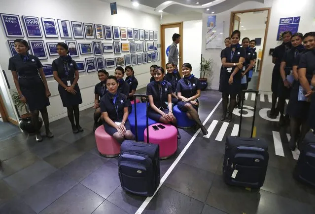 Prospective flight attendants listen to their instructor during a training session at Indigo Airlines' Ifly training centre in Gurgaon on the outskirts of New Delhi November 18, 2014. (Photo by Adnan Abidi/Reuters)