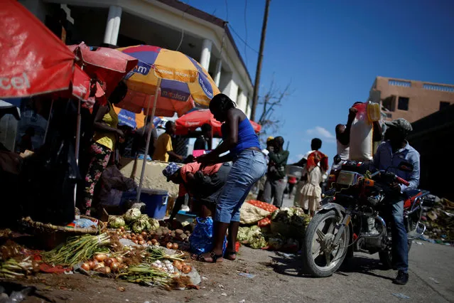 People buy food in a street market after Hurricane Matthew hit Jeremie, Haiti, October 12, 2016. (Photo by Carlos Garcia Rawlins/Reuters)