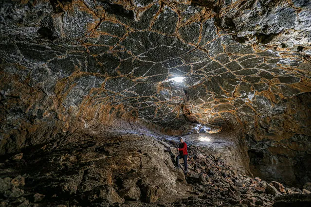 A view of the cave in volcanic Karacadag on November 08, 2020 in Diyarbakir, Turkey. Karacadag, a shield-made volcanic in Turkey's DiyarbakÄ±r, spread its lava to the surrounding areas in the eruptions that took place about 100 thousand years ago. Under the basalt plateau formed after the explosions, caves that reveal the fluidity of lava were formed. These caves attract the attention of nature lovers with their natural beauty. (Photo by Hasan Namli/Anadolu Agency via Getty Images)