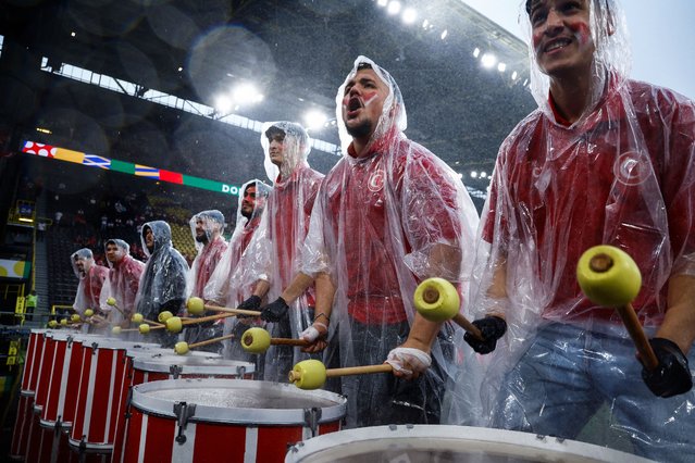 Turkey's supporters play drums as it rains ahead of UEFA Euro 2024 Group F football match between Turkey and Georgia at the BVB Stadion in Dortmund on June 18, 2024. (Photo by Kenzo Tribouillard/AFP Photo)