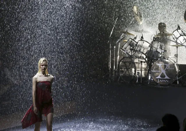 A model displays a creation designed by Japanese musician Yoshiki as he plays the drum during the opening of the 2017 Spring/Summer Collection at the Tokyo Fashion Week in Tokyo, Monday, October 17, 2016. (Photo by Koji Sasahara/AP Photo)