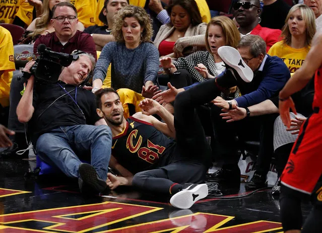 Cleveland Cavaliers guard Jose Calderon (C) of Spain falls out of bounds into a television cameraman after being fouled in the second half of the NBA Eastern Conference Semifinals basketball game four between Toronto Raptors and the Cleveland Cavaliers the at Quicken Loans Arena in Cleveland, Ohio, USA, 07 May 2018. (Photo by David Maxwell/EPA/EFE)