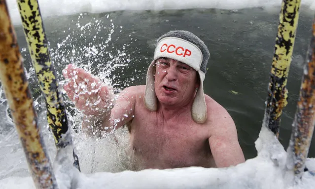 A man wearing a hat with USSR (Soviet Union) logo gets out of the ice cold water during a frosty day in Siberian city of Omsk, Russia, Saturday, December 26, 2020. The temperature in Omsk dropped down to –32 degree Celsius (–25,6 degree Fahrenheit). (Photo by Evgeniy Sofiychuk/AP Photo)