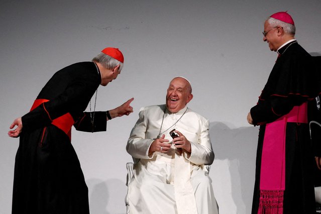 Pope Francis sits down, with cardinal Matteo Zuppi and Italian archbishop of Catania Luigi Renna standing next to him, as he attends the 50th Social Week of Catholics at the “Generali Convention Center” in Trieste, Italy, on July 7, 2024. (Photo by Alessandro Garofalo/Reuters)