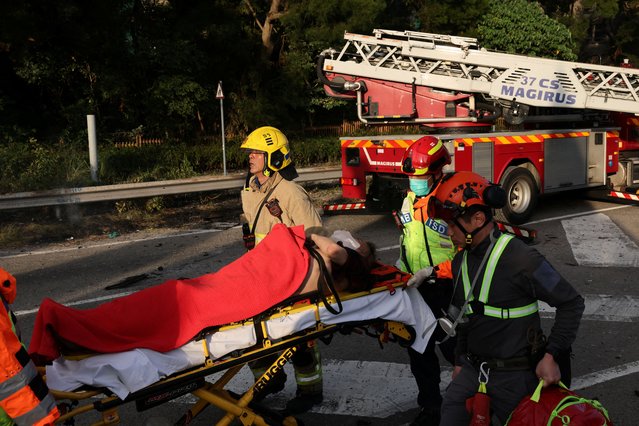 Emergency workers shift a casualty following a fire across multiple buildings at Wang Fuk Court housing estate, in Tai Po, Hong Kong, China, on November 26, 2025. (Photo by Tyrone Siu/Reuters)