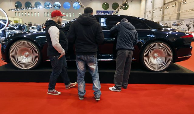 Visitors look at the concept car "Giugiaro GEA concept" at the Essen Motor Show in Essen, Germany, November 27, 2015. (Photo by Ina Fassbender/Reuters)
