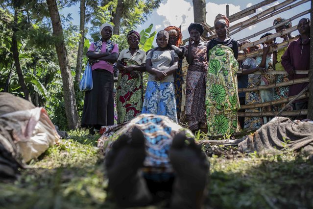 Relatives gather to identify bodies in the village of Nyamukubi, South Kivu province, Congo, Saturday, May 6, 2023. The death toll from flash floods and landslides in eastern Congo has risen to over 150, with some 100 people still missing, according to a provisional assessment given by the governor and authorities in the country's South Kivu province. (Photo by Moses Sawasawa/AP Photo)