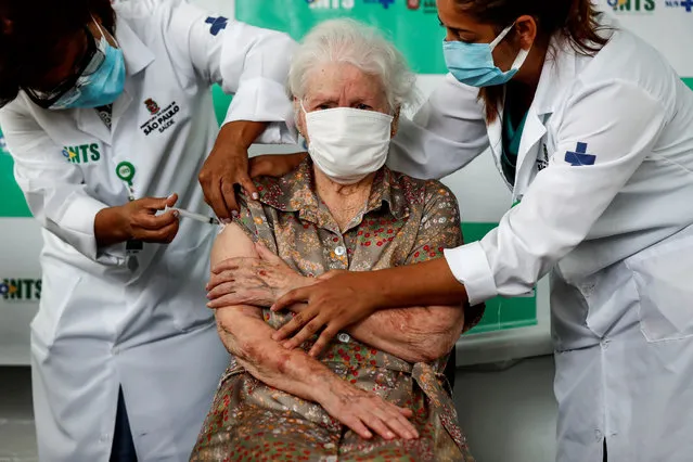 Mrs. Maria Breda, 96, receives a first dose of the Coronavac vaccine against covid-19, at a basic health unit (UBS) in south Sao Paulo, Brazil, 05 February 2021. The Mayor's Office of Sao Paulo began this Friday immunization against covid-19 for elderly people over 90 years old. (Photo by Sebastiao Moreira/EPA/EFE)