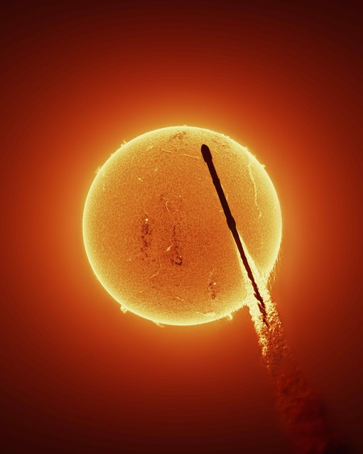 A rocket slices across the face of the sun in the first photograph of its kind, taken from Merritt Island, Florida on November 17, 2025, using a hydrogen-alpha telescope eight miles from the launch site. (Photo by Andrew McCarthy/Two Point O Media)