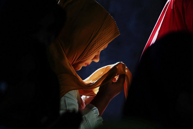 A Muslim woman prays at the remains of the Meuraxa hospital building that was hit by the Indian Ocean tsunami in 2004, next to Ulee Lheue mass grave, during the 20-years anniversary of the Indian Ocean tsunami, in Banda Aceh, Aceh, Indonesia, on December 26, 2024. (Photo by Willy Kurniawan/Reuters)
