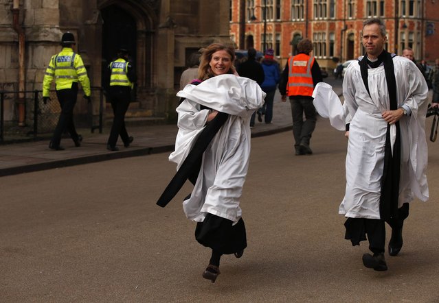 Members of the clergy rush towards York Minster before a service to consecrate Reverend Libby Lane as the first female Bishop in the Church of England, in York, northern England January 26, 2015. (Photo by Phil Noble/Reuters)
