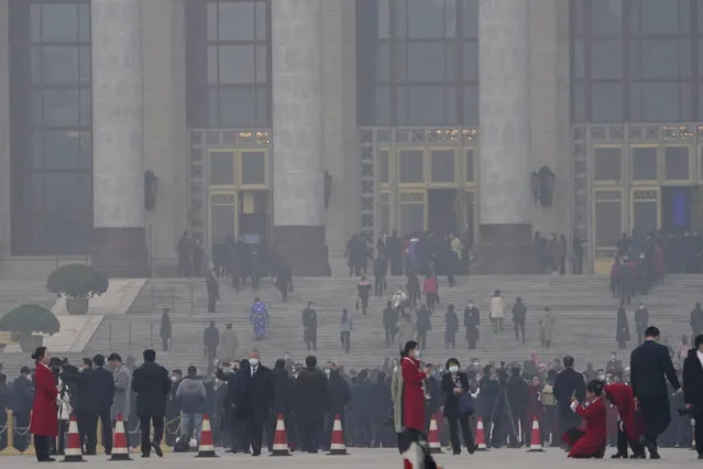 Delegates arrive at the Great Hall of the People for the opening session of the annual National People's Congress held in Beijing on Friday, March 5, 2021. (Photo by Ng Han Guan/AP Photo)