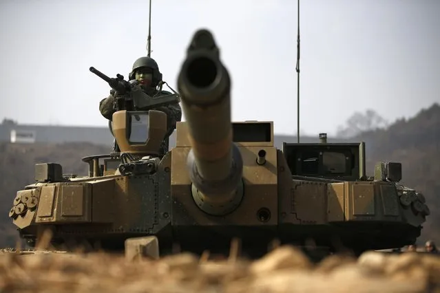 A South Korean army soldier takes position at the army's K-2 tank during an annual live-fire military exercise in Yangpyeong February 11, 2015. (Photo by Kim Hong-Ji/Reuters)