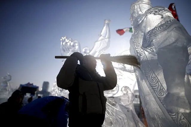 A worker polishes an ice sculpture ahead of the Harbin International Ice and Snow Festival in the northern city of Harbin, Heilongjiang province, January 4, 2016. (Photo by Aly Song/Reuters)