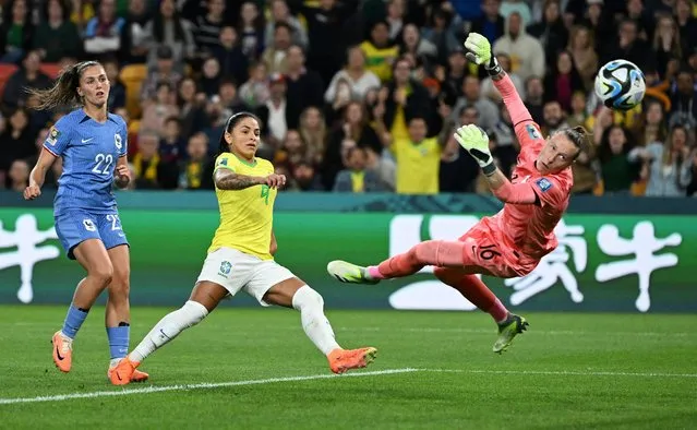 Debinha of Brazil scores her team's first goal past Pauline Peyraud-Magnin of France during the FIFA Women's World Cup Australia & New Zealand 2023 Group F match between France and Brazil at Brisbane Stadium on July 29, 2023 in Brisbane, Australia. (Photo by Dan Peled/Reuters)