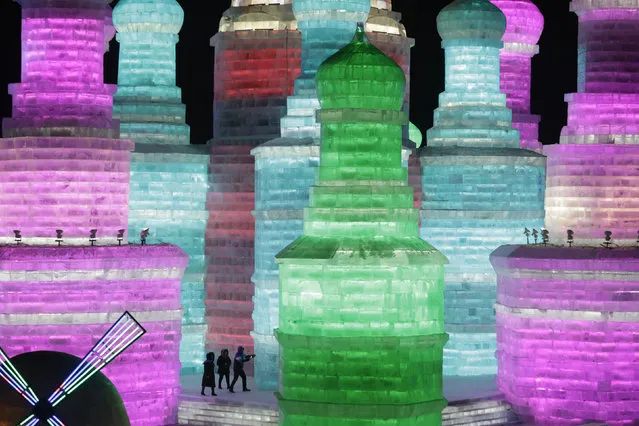 People visit ice sculptures illuminated by coloured lights on the opening day of the Harbin International Ice and Snow Festival in the northern city of Harbin, Heilongjiang province, China, January 5, 2016. (Photo by Aly Song/Reuters)