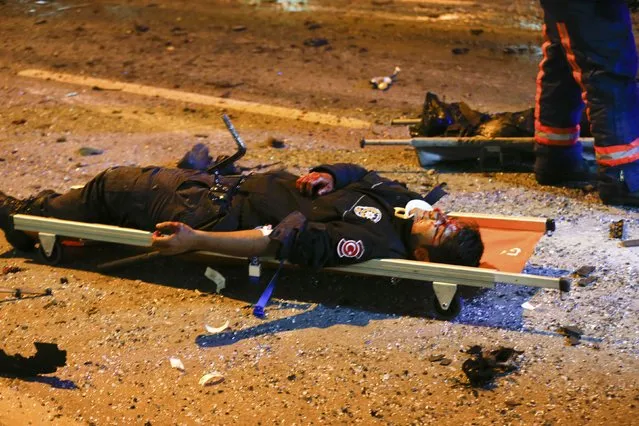 An injured policeman lies on a stretcher at the site of an explosion in central Istanbul, Turkey, December 10, 2016. (Photo by Murad Sezer/Reuters)