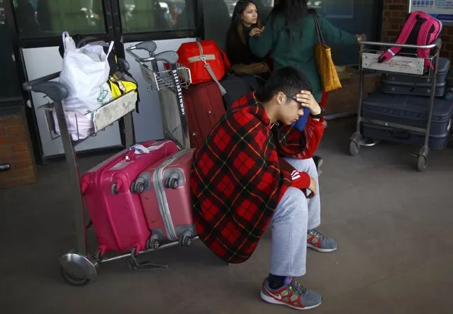 A stranded passenger waits at Tribhuvan International Airport following the airport closure after a Turkish Airlines plane overshot a runway in Kathmandu March 4, 2015. According to local media, all passengers and crew members of the flight were rescued. REUTERS/Navesh Chitrakar 