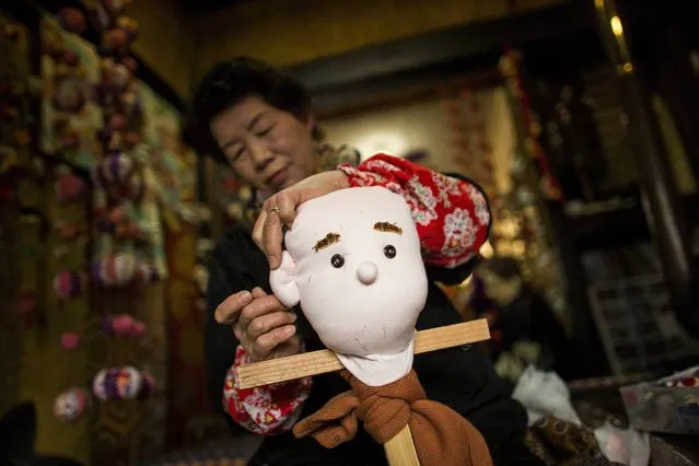 Tsukimi Ayano sows an ear onto a scarecrow in her house in the mountain village of Nagoro on Shikoku Island in southern Japan February 24, 2015. (Photo by Thomas Peter/Reuters)