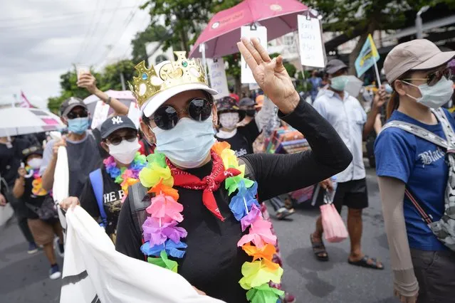 A pro-democracy supporter shows the three-finger salute of defiance during a demonstration in Bangkok, Thailand, Thursday, June 24, 2021. Anti-government protests  expected to resume in Bangkok after a long break due partly to a surge in COVID-19 cases. Gatherings are planned for several locations across the capital, despite health officials mulling a week-long lockdown in Bangkok  to control a rampant virus surge. (Photo by Sakchai Lalit/AP Photo)