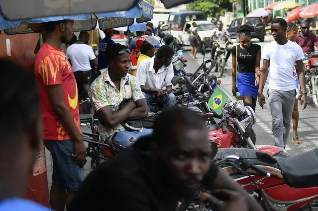 Mototaxi drivers wait for customers in Port-au-Prince, Haiti, Saturday, July 10, 2021, three days after President Jovenel Moise was assassinated in his home. (Photo by Matias Delacroix/AP Photo)