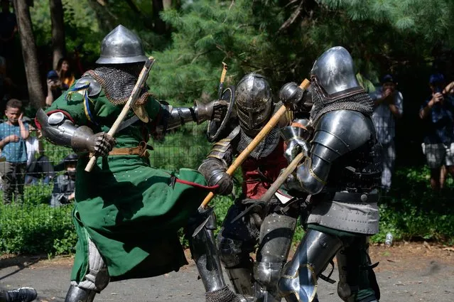 Members of the “Gladiators NYC” armored combat group fight in Central Park, New York on July 10, 2021. Once a month a bucolic corner of New York's Central Park becomes an impromptu battlefield as combatants in full medieval armour vie before baying picnickers and passersby, in a demonstration of brute strength and swordsmanship. (Photo by Ed Jones/AFP Photo)