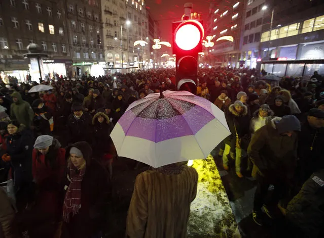 People march during a protest against populist President Aleksandar Vucic in Belgrade, Serbia, Saturday, January 5, 2019. Thousands of people have protested in Serbia for a fifth consecutive week over what they say has been a stifling of democratic freedoms under President Aleksandar Vucic. (Photo by Darko Vojinovic/AP Photo)
