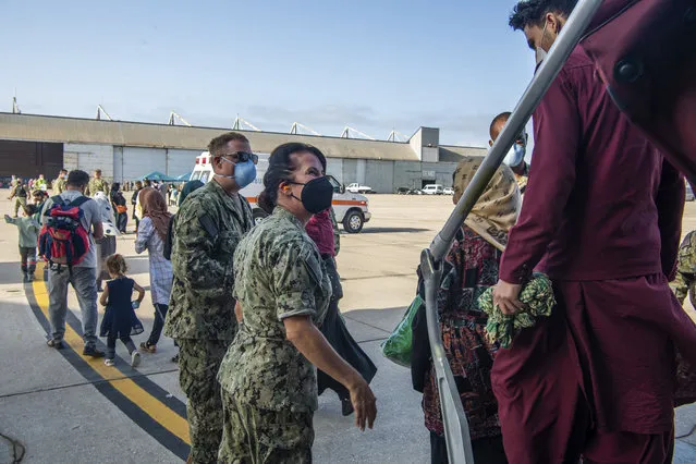 In this image provided by the U.S. Navy and taken on the military base in Rota, near Cadiz in southern Spain on Friday August 27, 2021, evacuees from Afghanistan arrive at the Rota navy base. (Photo by U.S. Navy Mass Communication Specialist 2nd Class John Owen via AP Photo)