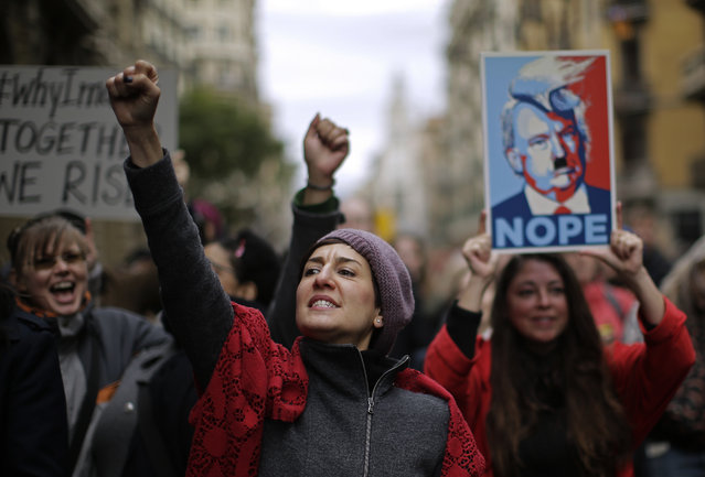 People shouts slogans during the Women's March rally in Barcelona, Spain, Saturday, January 21, 2017. The march was held in solidarity with the Women's March on Washington, advocating women's rights and opposing Donald Trump's presidency. (Photo by Manu Fernandez/AP Photo)
