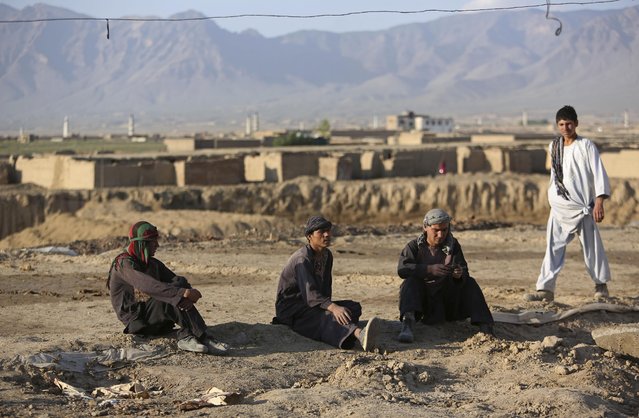 Afghan day laborers take a rest after work at a brick factory on the outskirts of Kabul, Afghanistan, Monday, April 20, 2015. (Photo by Rahmat Gul/AP Photo)
