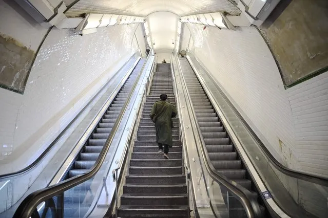 A commuter walks upstairs at Saint-Lazare metro-RER station in Paris on November 10, 2022, during a strike. Seven lines of the Paris metro will be completely closed and seven others only open during rush hour due to a strike on November 10, 2022 to demand wage increases and improved working conditions, the RATP said on November 8, 2022. European workers squeezed by the soaring cost of living went on strike in Belgium and Greece on November 9, 2022, with stoppages threatening to paralyse parts of Britain, France and Spain in coming days. (Photo by Bertrand Guay/AFP Photo)
