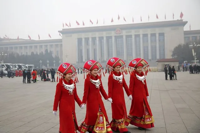 Hostesses hold their hands as they walk outside the Great Hall of the People during meetings ahead of Saturday's opening ceremony of the National People's Congress (NPC), in Beijing, China March 4, 2016. (Photo by Damir Sagolj/Reuters)