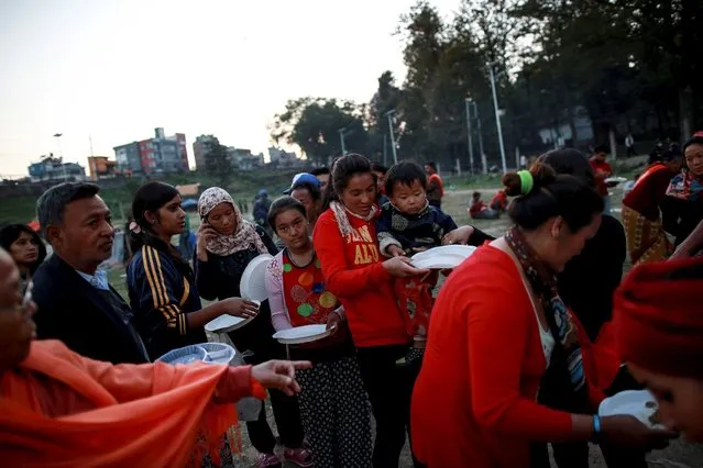 People displaced after Saturday's earthquake stand in a queue to get food from a local organisation at an open ground in Kathmandu, Nepal, April 27, 2015. (Photo by Danish Siddiqui/Reuters)
