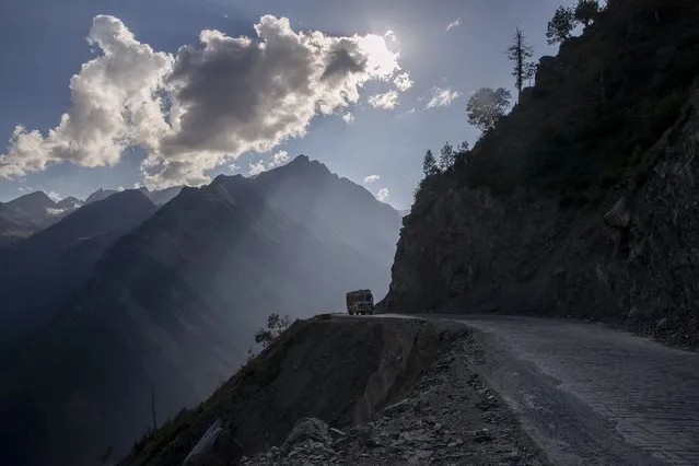 A lone truck travels on the Zojila Pass, northeast of Srinagar, Indian controlled Kashmir, Monday, September 27, 2021. High in a rocky Himalayan mountain range, hundreds of people are working on an ambitious project to drill tunnels and construct bridges to connect the Kashmir Valley with Ladakh, a cold-desert region isolated half the year because of massive snowfall. The $932 million project’s last tunnel, about 14 kilometers (9 miles) long, will bypass the challenging Zojila pass and connect Sonamarg with Ladakh. Officials say it will be India’s longest and highest tunnel at 11,500 feet (3,485 meters). (Photo by Dar Yasin/AP Photo)