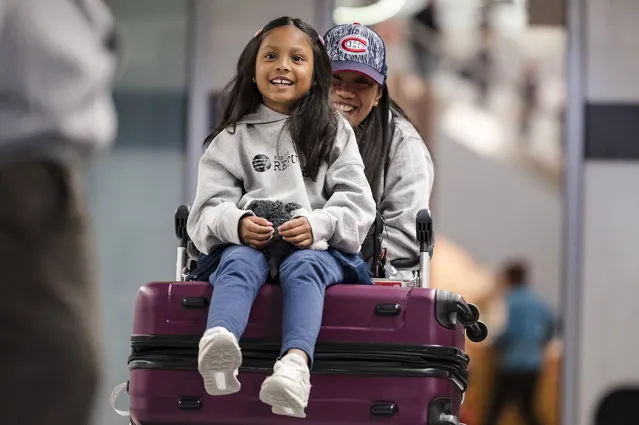 Vanessa Rodel and her 7-year-old daughter Keana exit Lester B. Pearson Airport in Toronto on Monday, March 25, 2019. The Filipino woman who helped shelter former NSA contractor Edward Snowden when he fled to Hong Kong has been granted refugee status in Canada. (Photo by Christopher Katsarov/The Canadian Press via AP Photo)