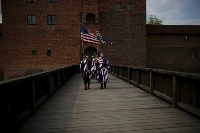 Members of the U.S. team walk with the national flags as they take part in the opening ceremony parade of the Medieval Combat World Championship at Malbork Castle, northern Poland, April 30, 2015. (Photo by Kacper Pempel/Reuters)