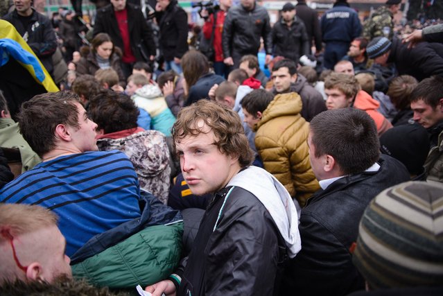 Pro-Western activists sit after being overpowered by pro-Russia activists after clashes at the local administration building in the northeastern city of Kharkiv, Ukraine, Saturday, March 1, 2014. (Photo by Olga Ivashchenko/AP Photo)