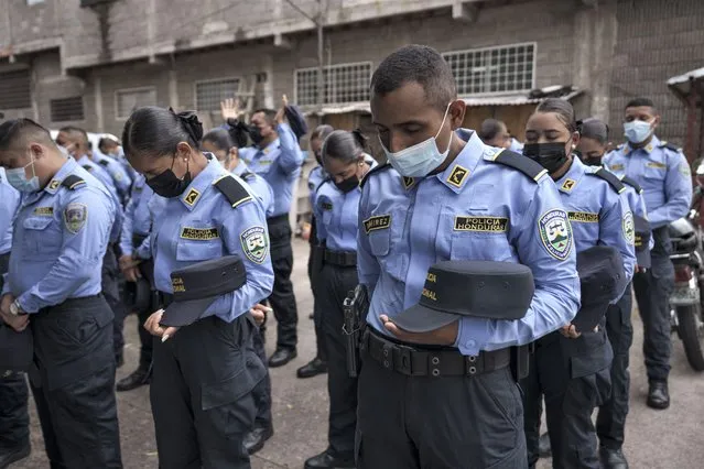National Police officers pray before beginning. their shift in the Kennedy neighborhood of Tegucigalpa, Honduras, Friday, November 26, 2021. Hondurans head to the polls on Sunday, Nov. 28 to elect a new president. (Photo by Moises Castillo/AP Photo)