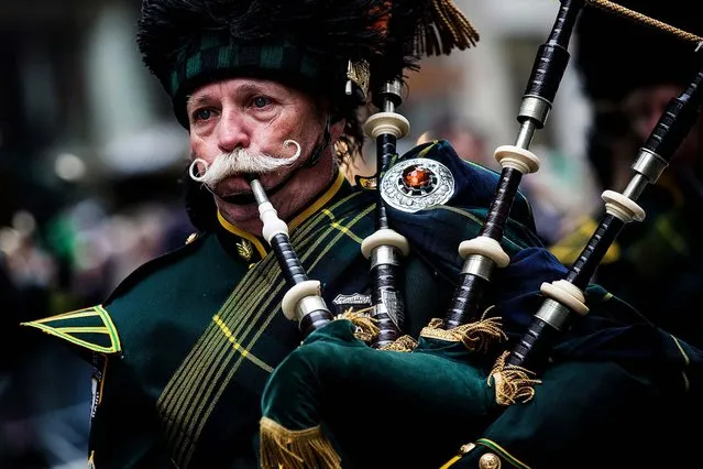 A bagpiper marches in the annual St. Patrick's Day Parade along Fifth Ave in Manhattan. Political controversy surrounded this year's parade, as New York City Mayor Bill De Blasio decided not to march due to the parade organizer's policy to ban participants that identify themselves as lesbian, gay, bisexual or transgender.  Heineken and Guinness announced earlier that they would drop their sponsorship of the parade for the same reasons. (Photo by Andrew Burton/Getty Images)