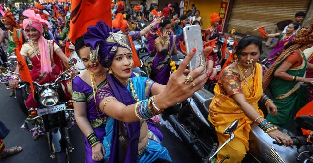 Indian people in traditional clothes participate in the procession to celebrate the Gudi Padwa, Maharashtrian's New Year in Mumbai, India on April 8, 2016. Gudi Padwa is the Hindu festival that falls on the first day of Chaitra month and marks the beginning of the Lunar Calendar, which dictates the dates for all Hindu festivals, also known as Panchang. (Photo by Divyakant Solanki/EPA)