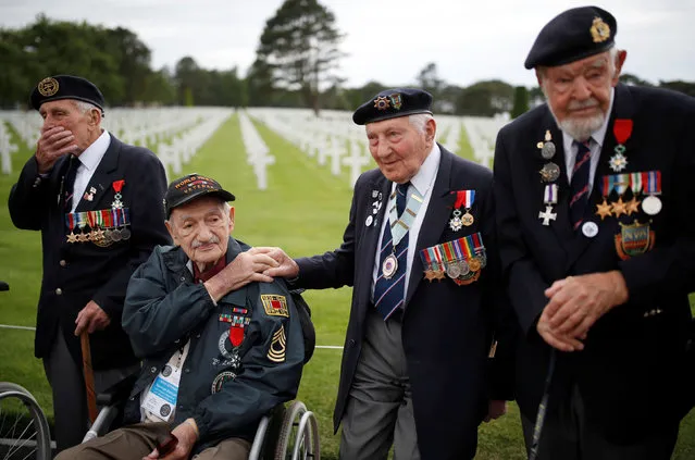 WWII D-Day veterans, including Richard Llewellyn and Mervyn Kersh from Britain and Norman Duncan from the U.S., attend a ceremony at Normandy American Cemetery and Memorial situated above Omaha Beach, as France prepares to commemorate the 75th anniversary of the D-Day, in Colleville-sur-Mer, France, June 4, 2019. (Photo by Christian Hartmann/Reuters)