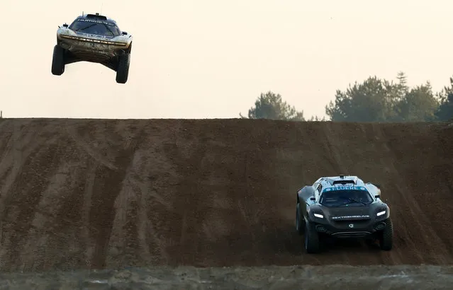 An electric SUV driven by Sara Price hurtles through the air at the Extreme E Crazy Race in Dorset, United Kingdom on December 18, 2021. (Photo by Bradley Collyer/PA Wire Press Association)