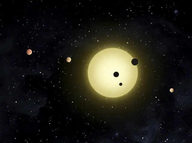 Kepler-11, a sun-like star around which six planets orbit. At times, two or more planets pass in front of the star at once, as shown in a simultaneous transit of three planets. (Photo by Tim Pyle/Reuters/NASA)