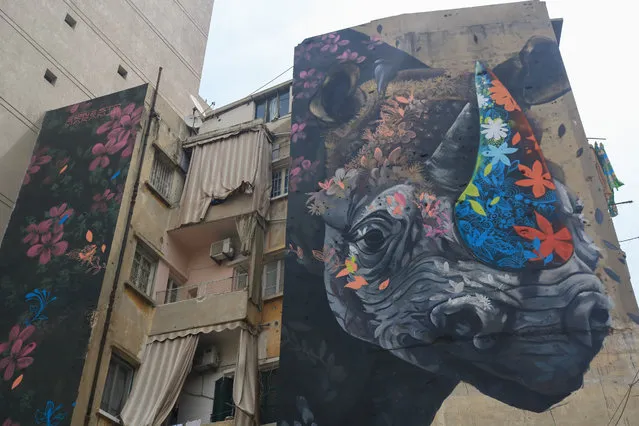 A mural of a rhinoceros adorns a building damaged during the Lebanese civil war in Beirut, Lebanon on April 24, 2019. (Photo by Amer Ghazzal/Barcroft Images)