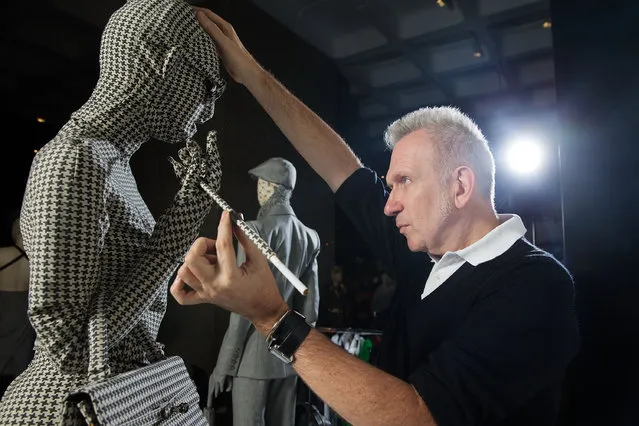 Jean Paul Gaultier makes final preparations to items of couture on a revolving runway at the Barbican Centre on April 3, 2014 in London, England. “The Fashion World of Jean Paul Gaultier: From the Sidewalk to the Catwalk” at the Barbican Art Gallery is the first major exhibition devoted to the celebrated French couturier, and runs from 9 April to 25 August. (Photo by Matthew Lloyd/Getty Images)