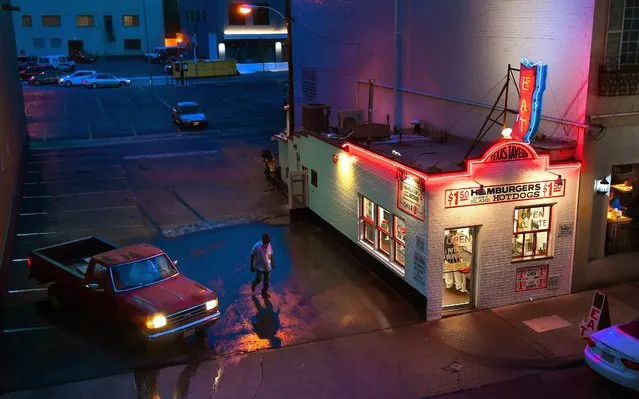 A man walks next to the Texas Tavern diner in Roanoke at night June 30, 2019. (Photo by Michael S. Williamson/The Washington Post)