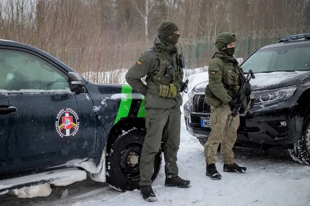 Members of the Lithuania State Border Guard Service and Lithuanian army soldiers patrol on the border with Belarus during a visit by participants of the Conference on Border Management near the village Kurmelionys, some 40km (24 miles) east of the capital Vilnius, Lithuania, Friday, January 21, 2022. The conference main objective is to discuss issues of fundamental importance in an open and informal way and to find common denominators on the issues of the protection of external borders, the response to hybrid attacks and the elimination of abuses of the EU asylum system. (Photo by Mindaugas Kulbis/AP Photo)